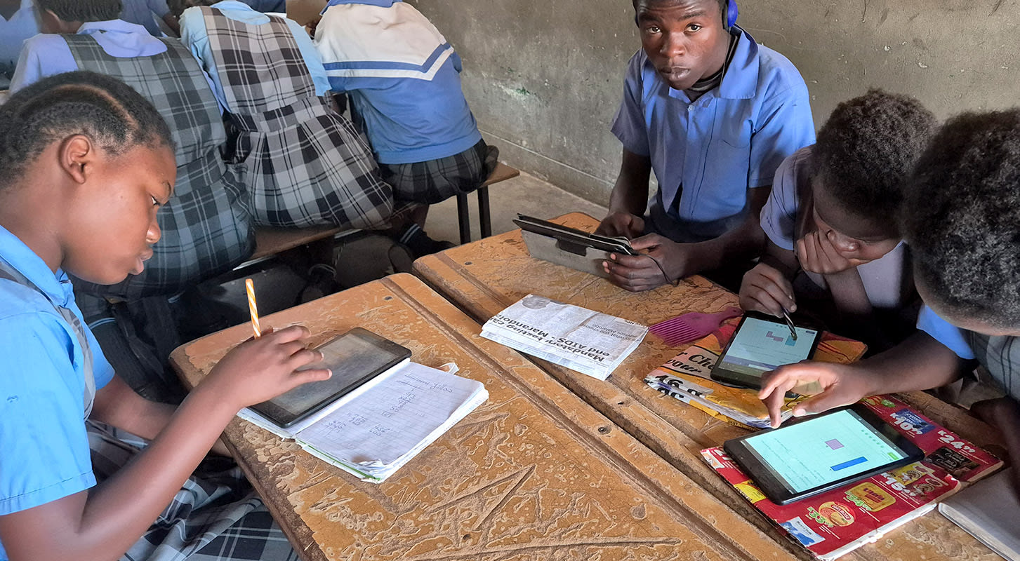 A classroom scene featuring students actively using various tablets for learning and collaboration.